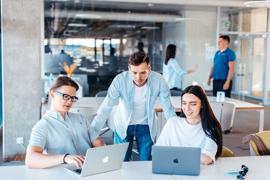 UK business owner and agency team reviewing an online store on a laptop