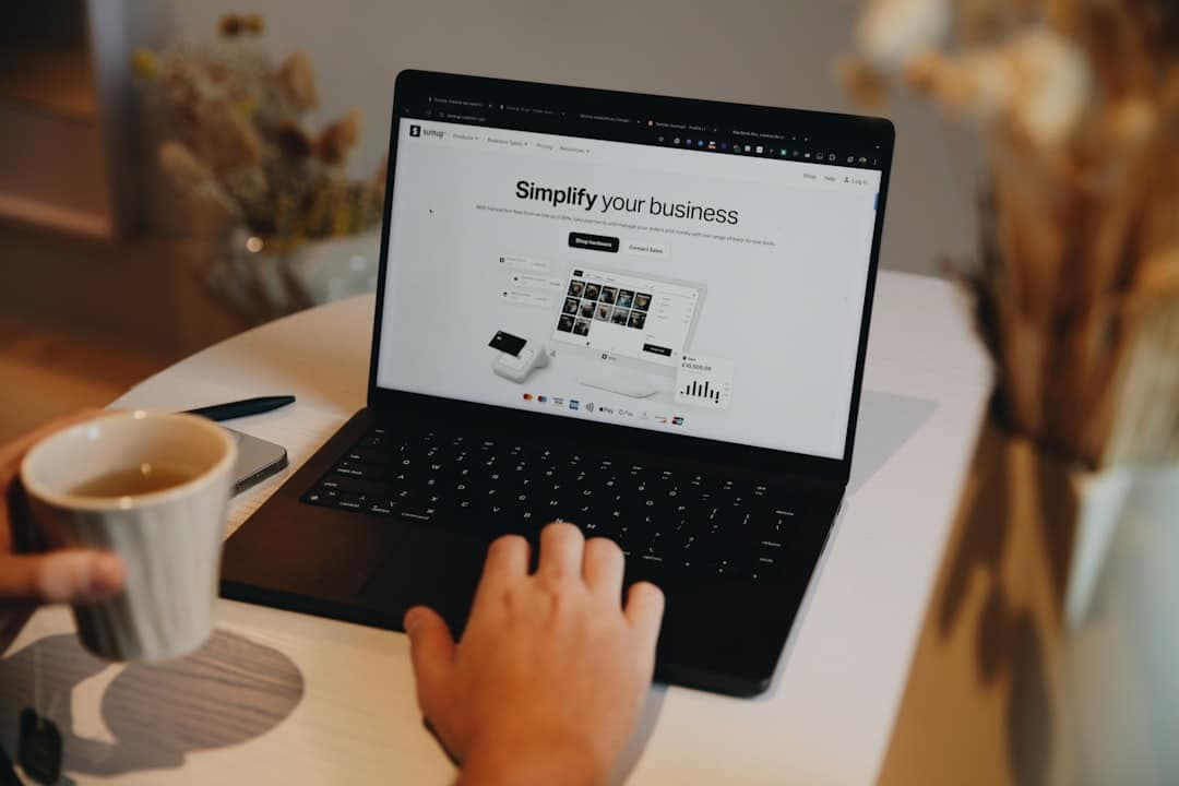 A small business owner checking their website on a laptop and a phone side by side