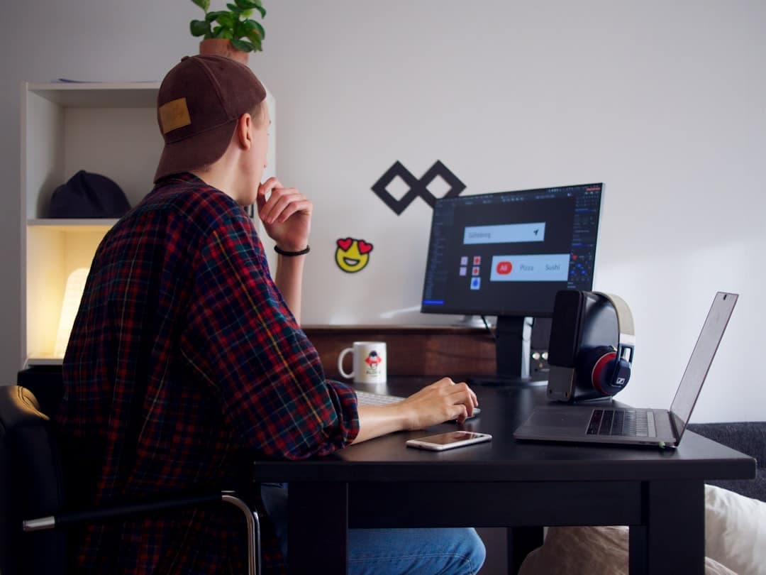 A web designer reviewing a contact form on a laptop
