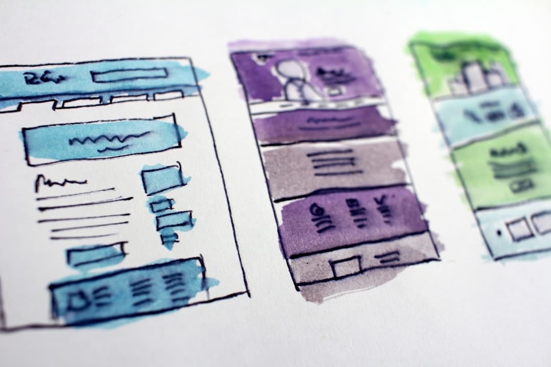 A web designer reviewing a wireframe alongside a Core Web Vitals score on screen