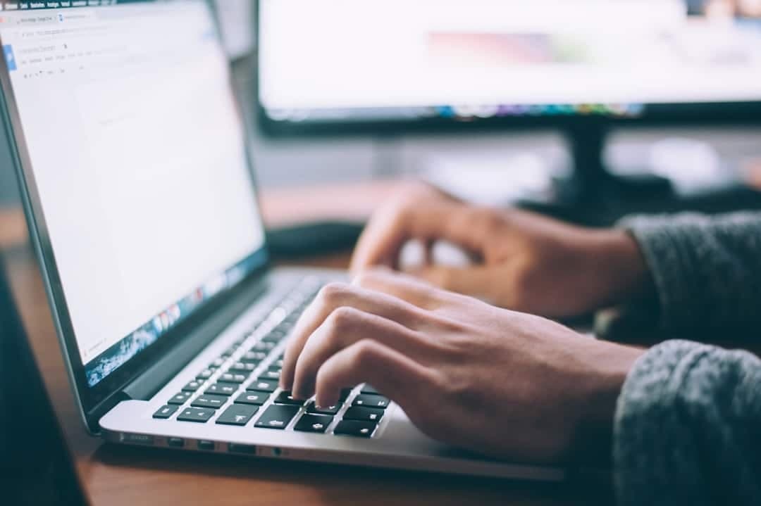 A developer running an accessibility audit on a laptop showing a WordPress or Shopify site